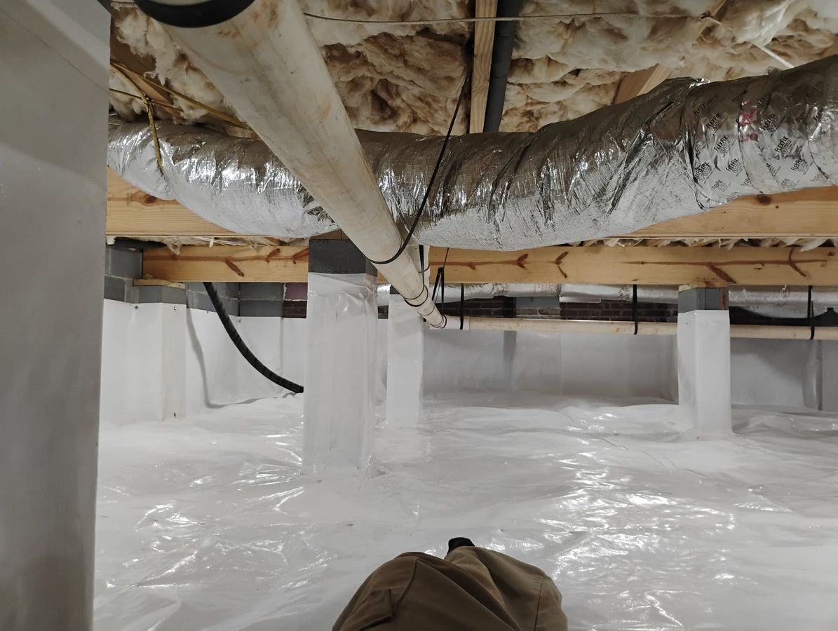 JHS crawl space waterproofing job photo showing crawl space drainage and moisture control work